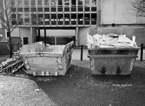 Busy construction site in Berkhamsted with waste clearance in progress