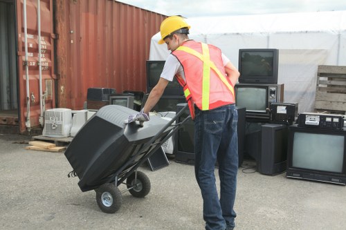 Operative inspecting a commercial waste container before collection